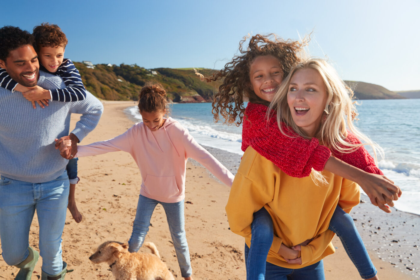 family smiling and enjoying the beach after lasik